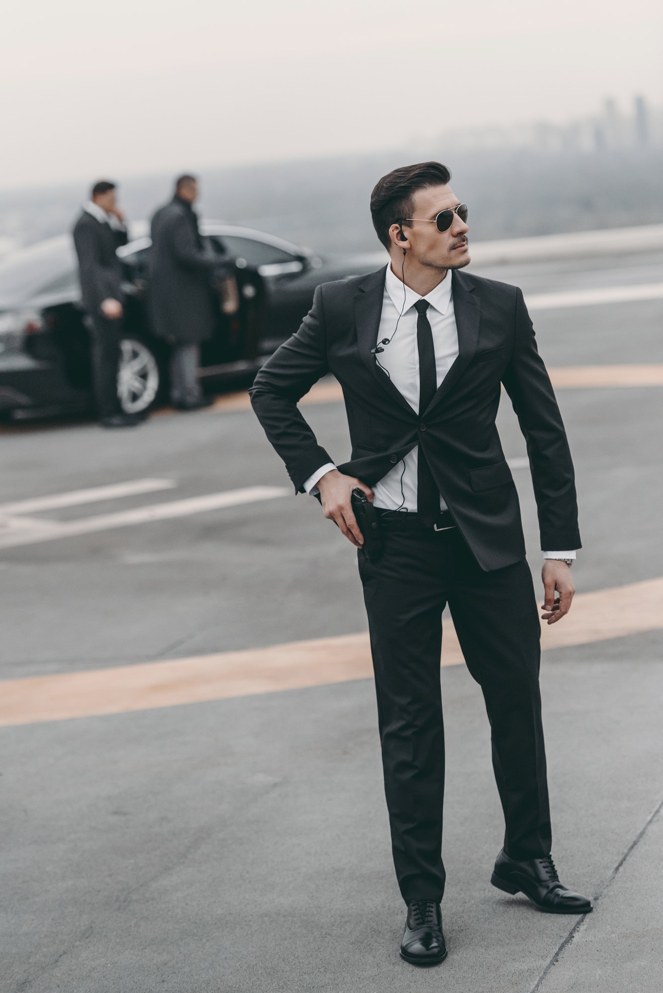 handsome-bodyguard-with-security-earpiece-and-gun